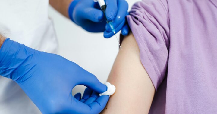 Close-Up Shot of a Health Worker Injecting a Vaccine on a Patient